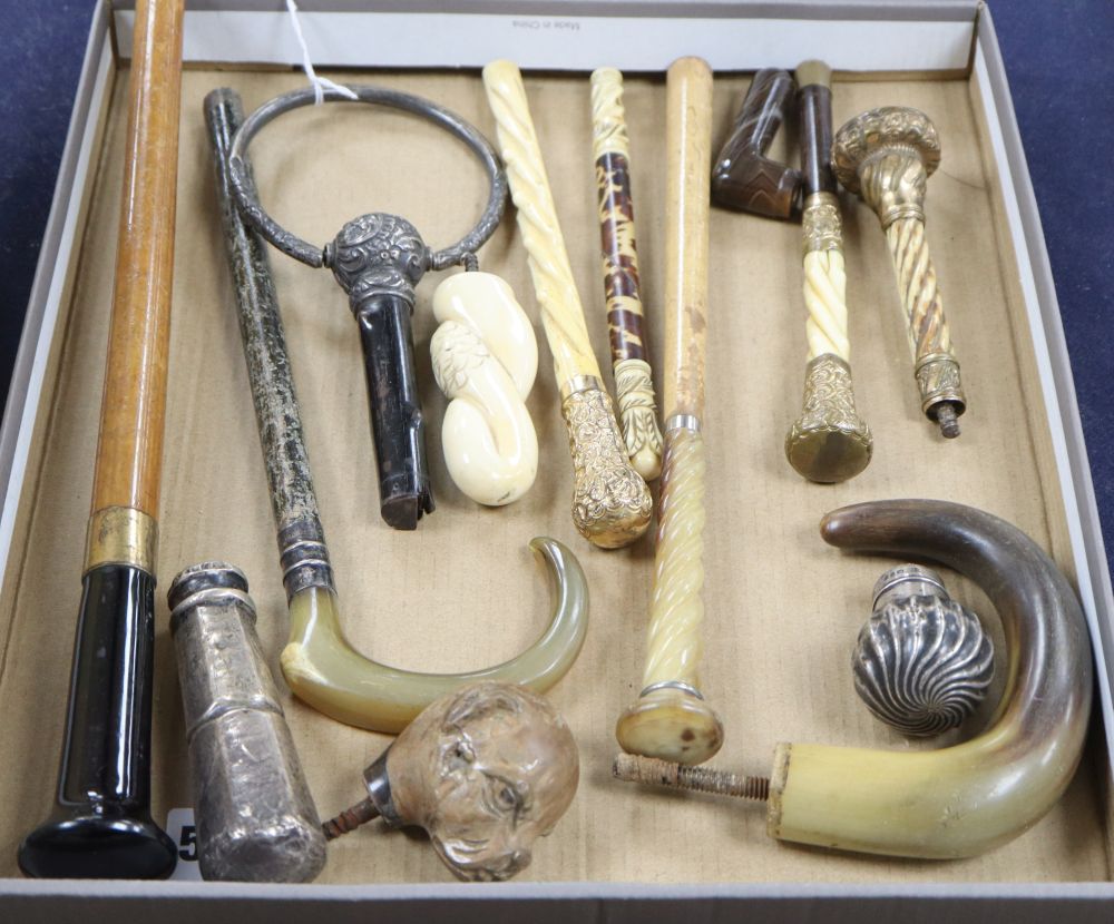 A group of silver, gilt metal and ivory walking cane and parasol handles.